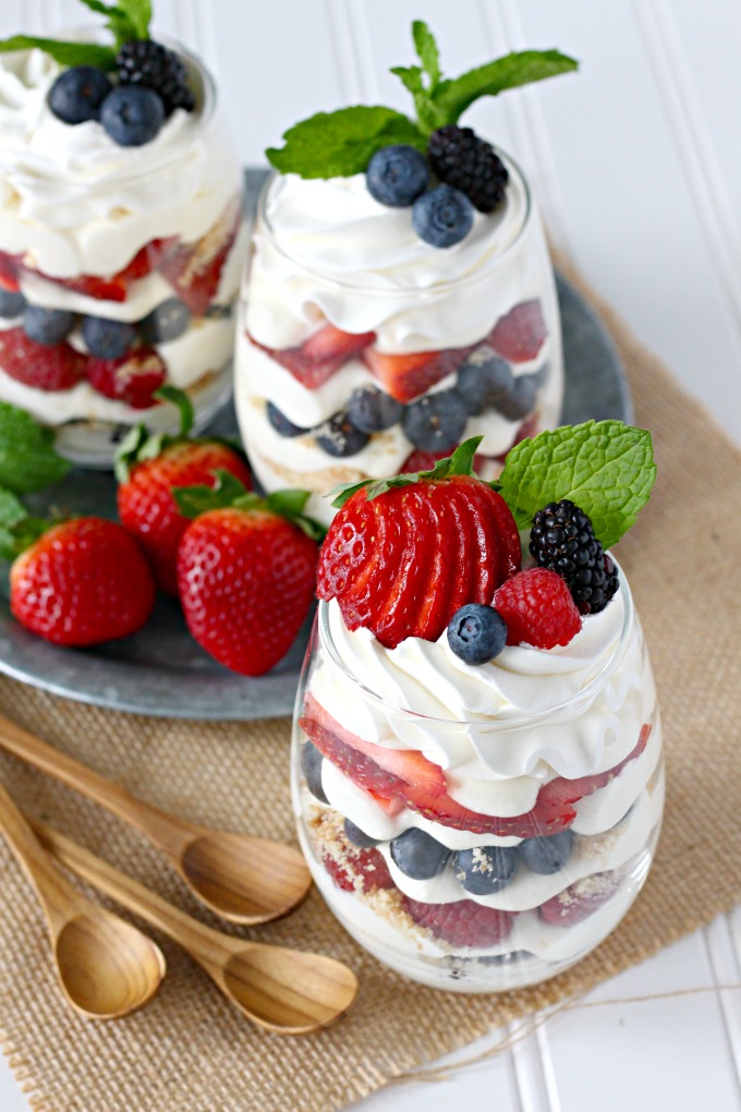 Individual berry cheesecake trifles with strawberries, blueberries, raspberries, blackberries, and no-bake cheesecake pudding mousse.