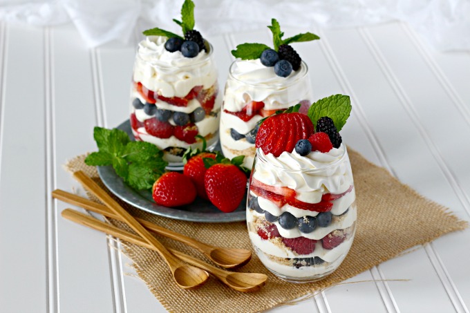 Individual berry cheesecake trifles with strawberries, blueberries, raspberries, blackberries, and no-bake cheesecake pudding mousse.