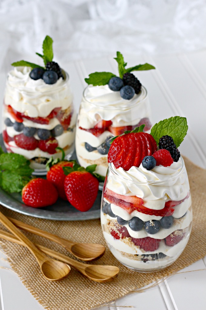 Individual berry cheesecake trifles with strawberries, blueberries, raspberries, blackberries, and no-bake cheesecake pudding mousse.