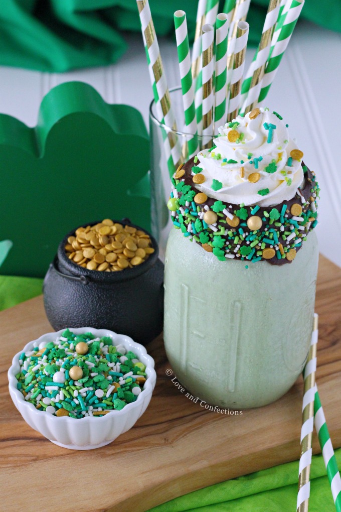 Green mint chocolate chip milkshake with chocolate coated sprinkle rim and whipped cream