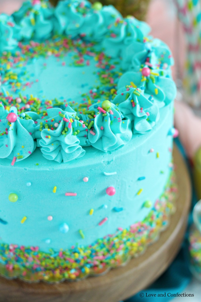 PIneapple cake with pineapple curd, teal frosting and tropical sprinkle mix