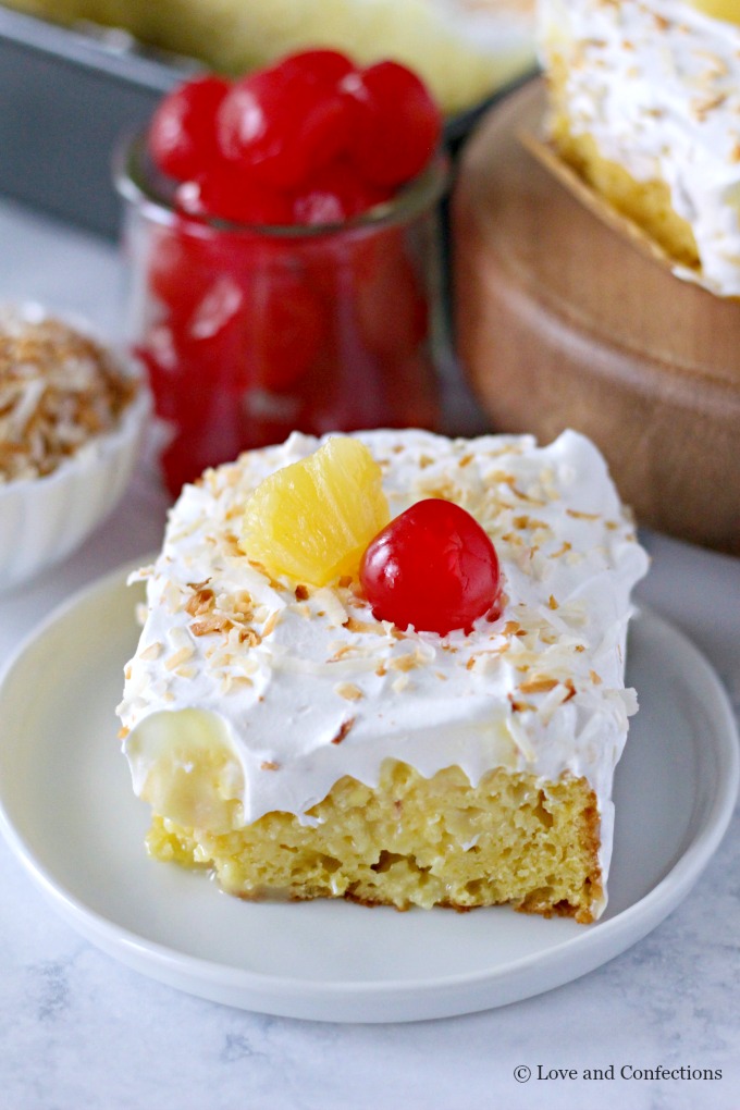 Easy Piña Colada Poke Cake - pineapple cake, coconut cream pudding, whipped topping, pineapple chunks and maraschino cherries